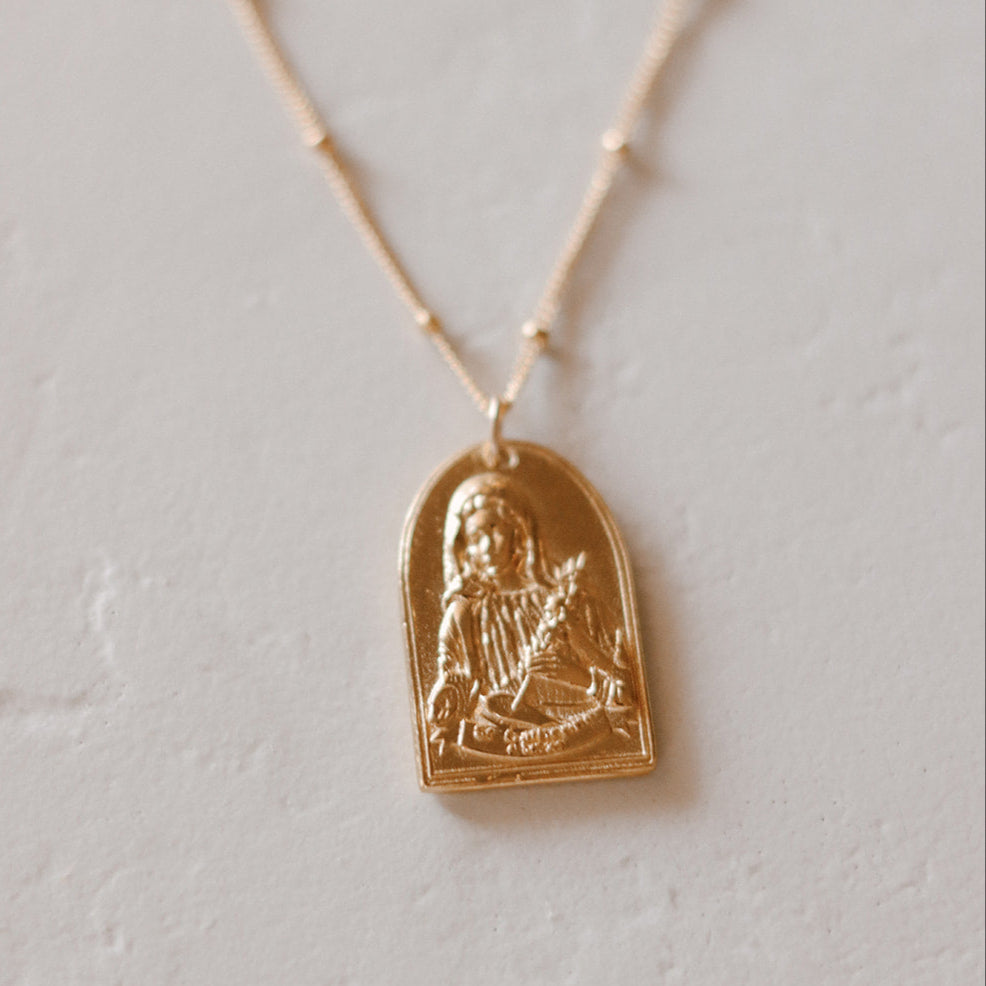 Gold-tone St. Catherine pendant necklace with arched saint medallion on chain