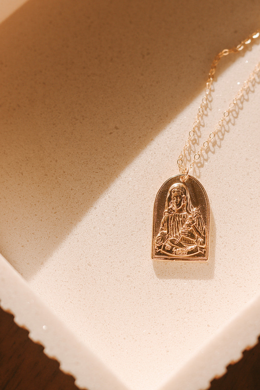 Gold-tone St. Catherine pendant necklace with arched Saint figure charm