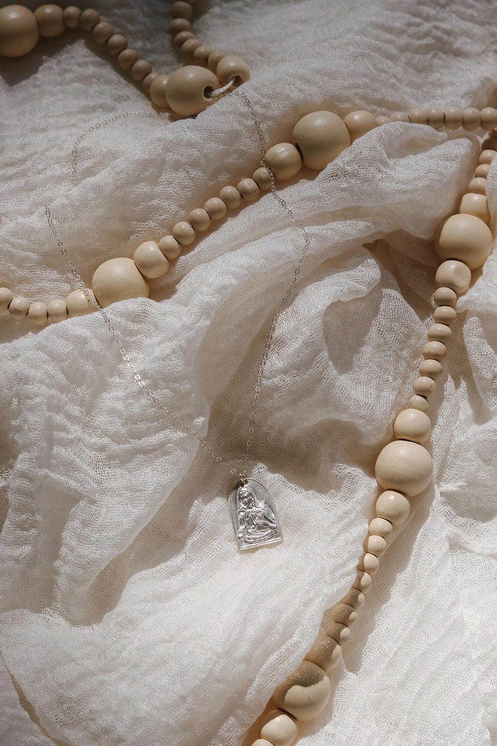 Sterling silver necklace with small heart pendant on an ivory beaded chain