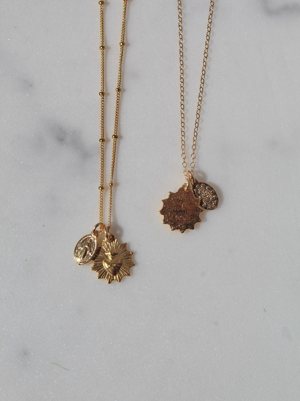 Gold-tone pendant necklace with sacred heart and medal charms, double chain