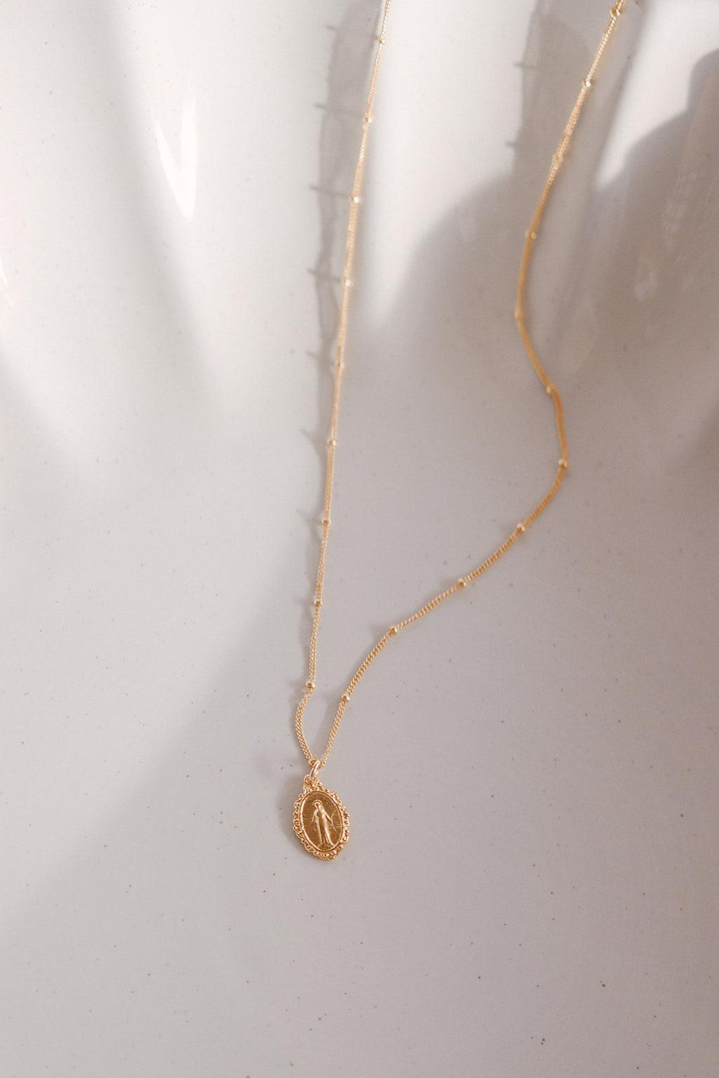 Gold-tone chain necklace with small oval Miraculous medal pendant