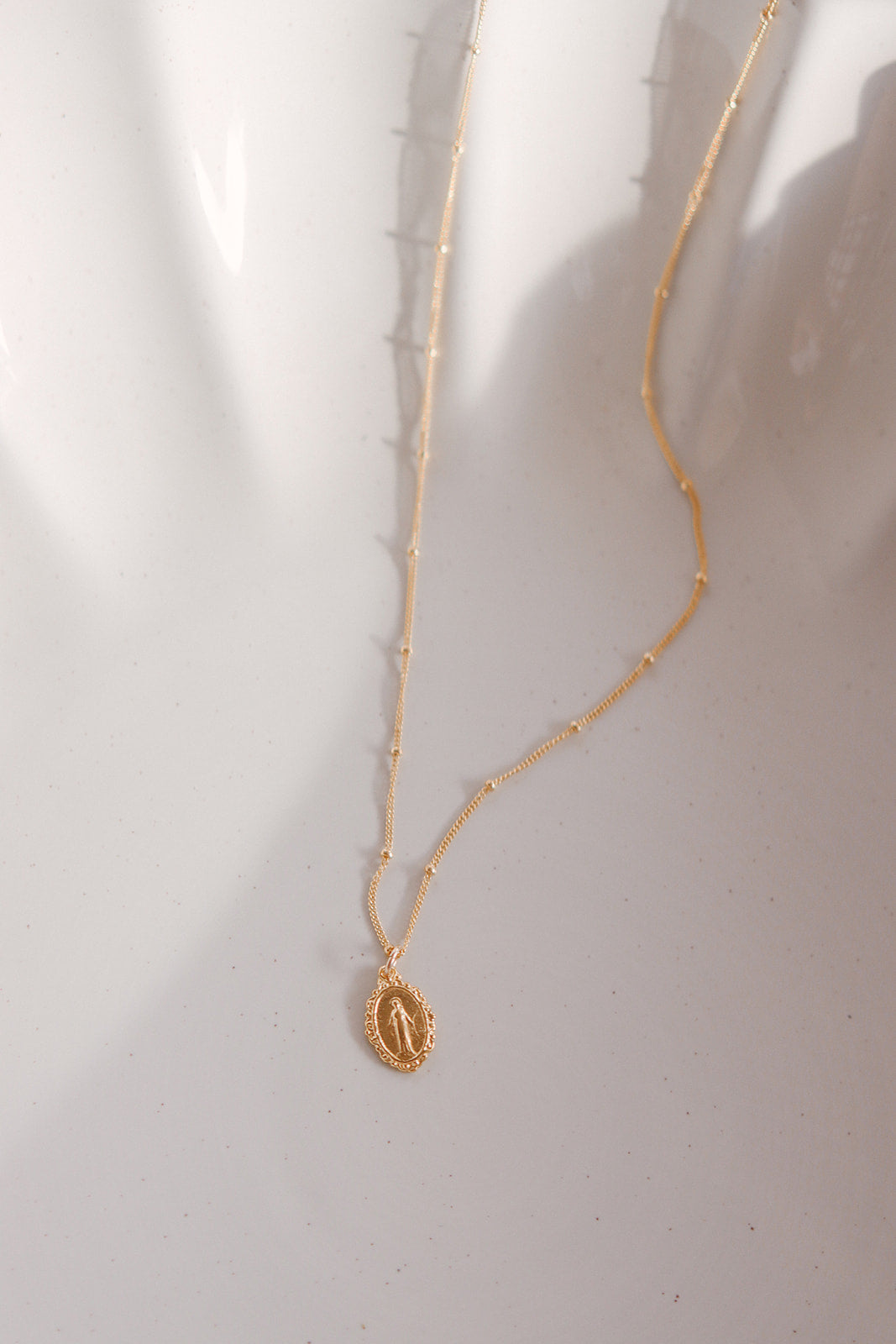 Gold-tone chain necklace with small oval Miraculous medal pendant