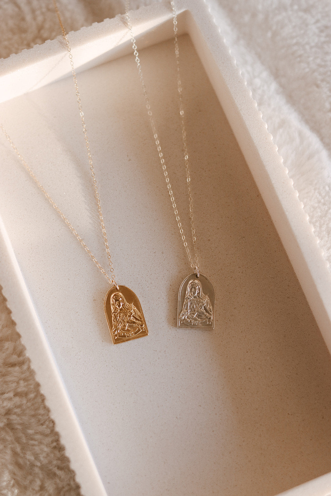 Two St. Catherine of Sweden pendant necklaces with gold and silver heart pendants