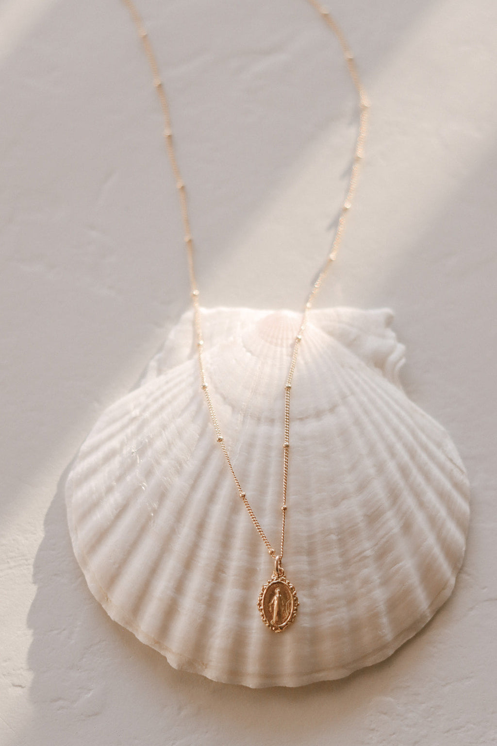 Gold-tone chain necklace with small oval Miraculous medal pendant