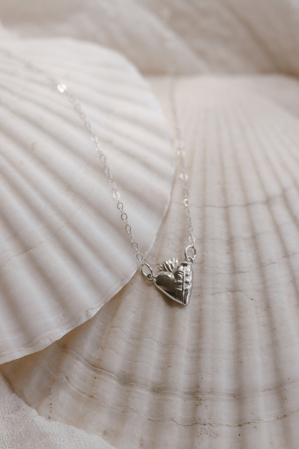 Sterling silver necklace with heart-shaped St. Joseph charm and fine chain