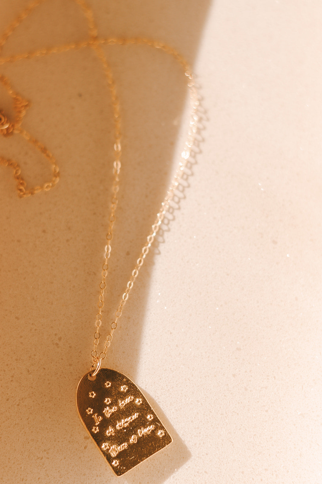 Gold St. Catherine of Sweden pendant necklace with heart-shaped back engraving on charm