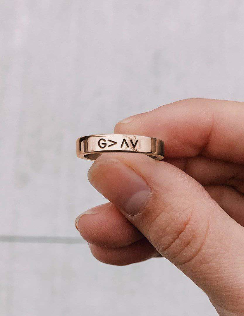Rose gold ring with raised engraved G>AV on the top edge