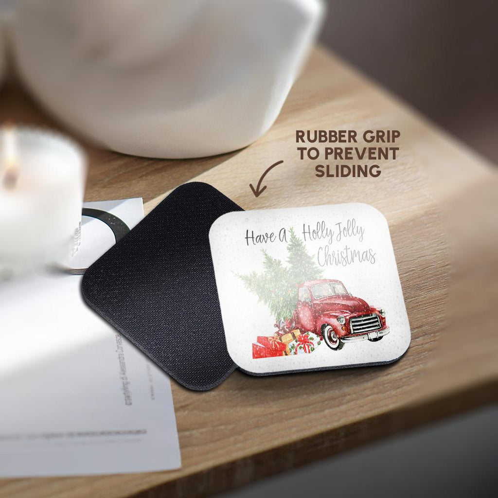 Black coaster mat holding a round coaster with red truck, holly, and 'Have a Holly Jolly Christmas'