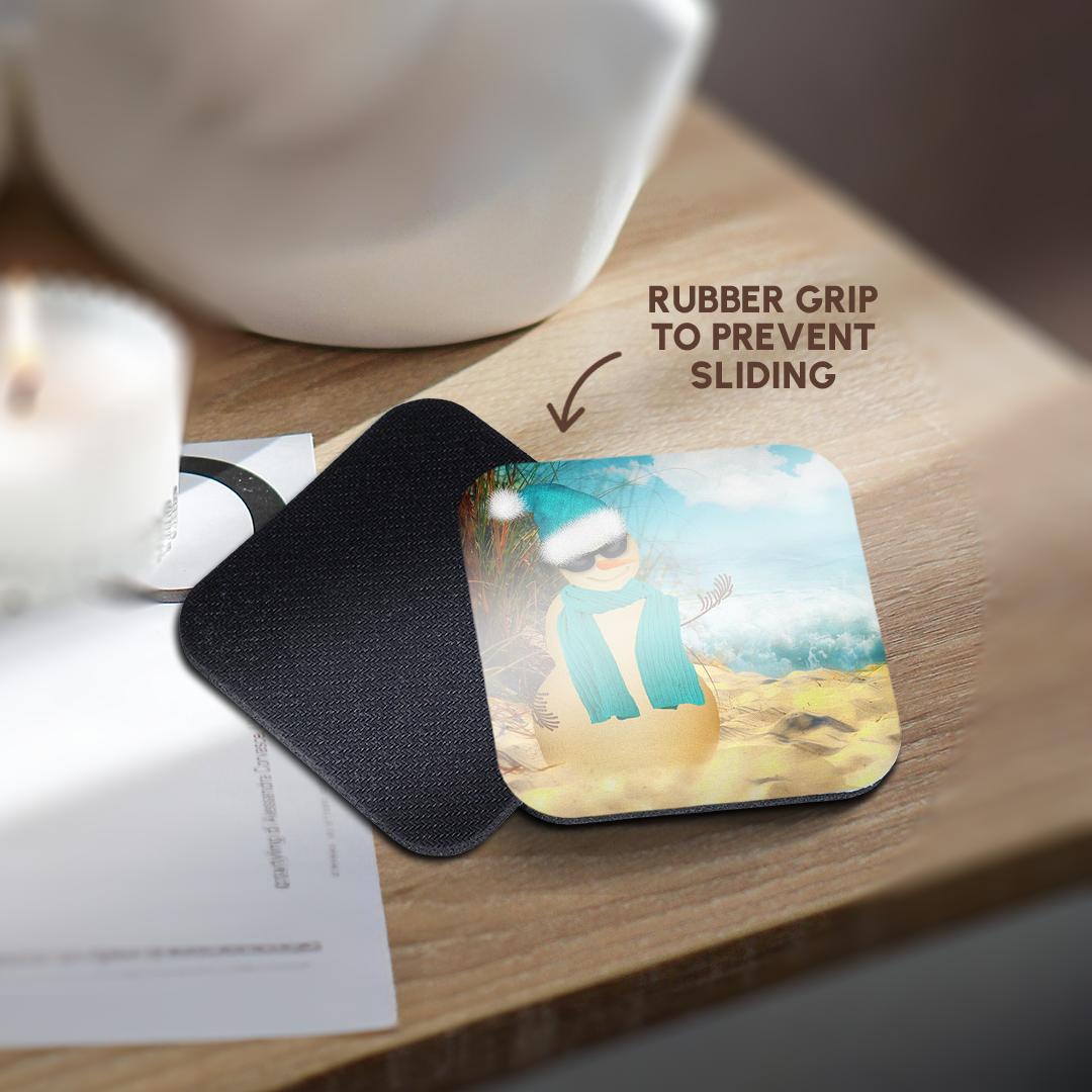 Square coaster with snowman beach scene and teal scarf, showing non-slip rubber backing