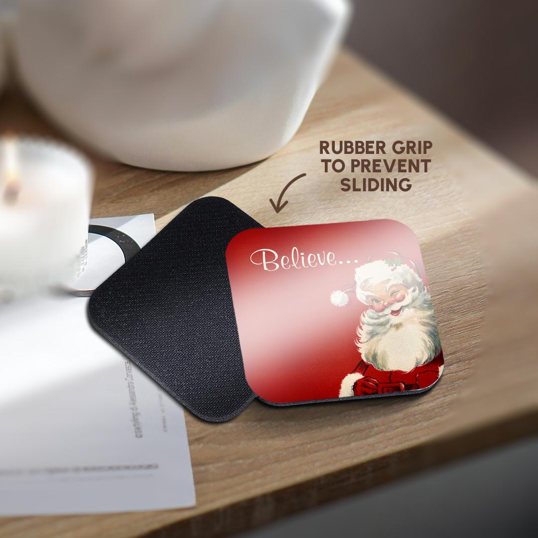 Red Santa coaster with “Believe...” on a black non-slip backing surface