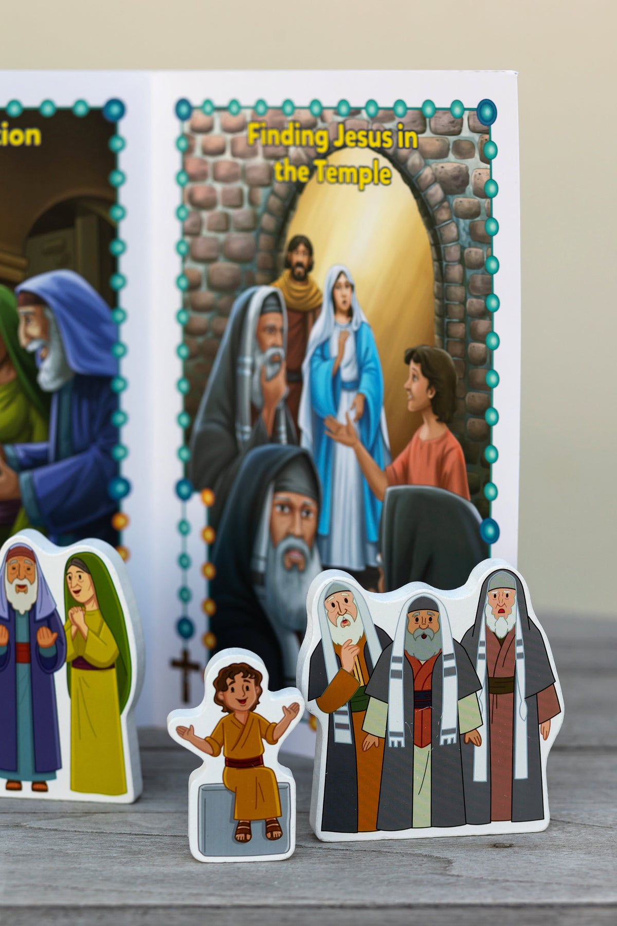 Rosary play set card panels featuring the temple scene with group standing character cutouts