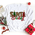 White crewneck sweatshirt with colorful 'Santa Daddy' graphic and Christmas trees
