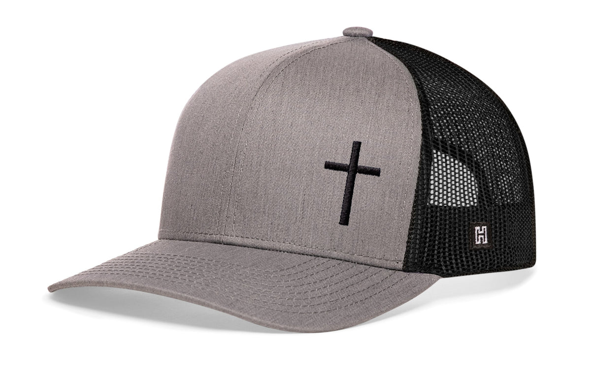 Gray trucker snapback cap with black cross on front, black mesh sides, snapback.