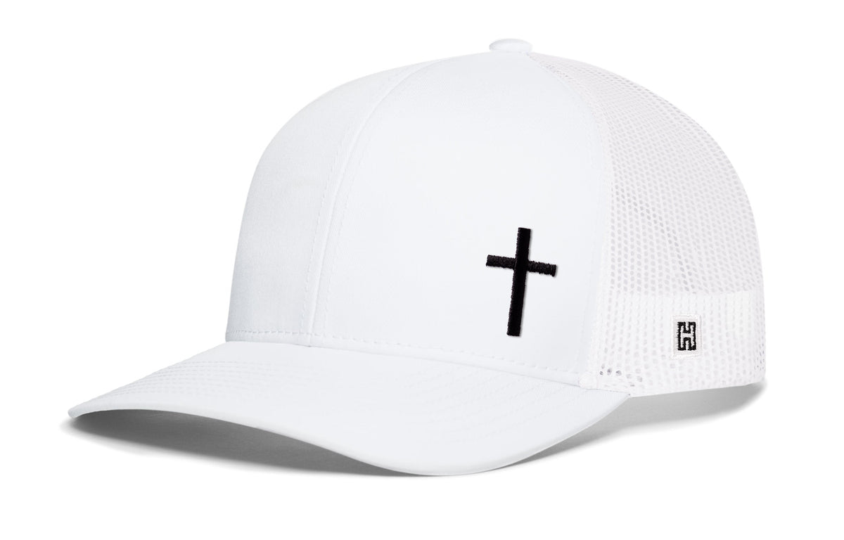White trucker snapback cap with black cross on front, white mesh sides, snapback.