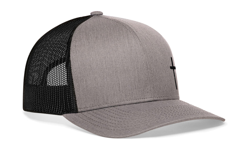 Gray trucker snapback cap with dark cross mark, black mesh sides, snapback.
