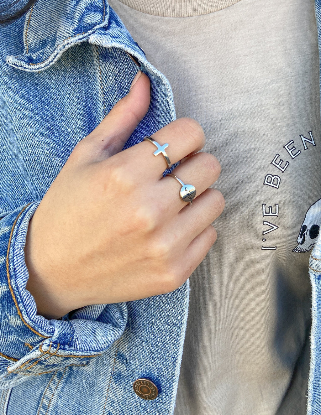 Silver cross ring with light blue enamel cross on finger