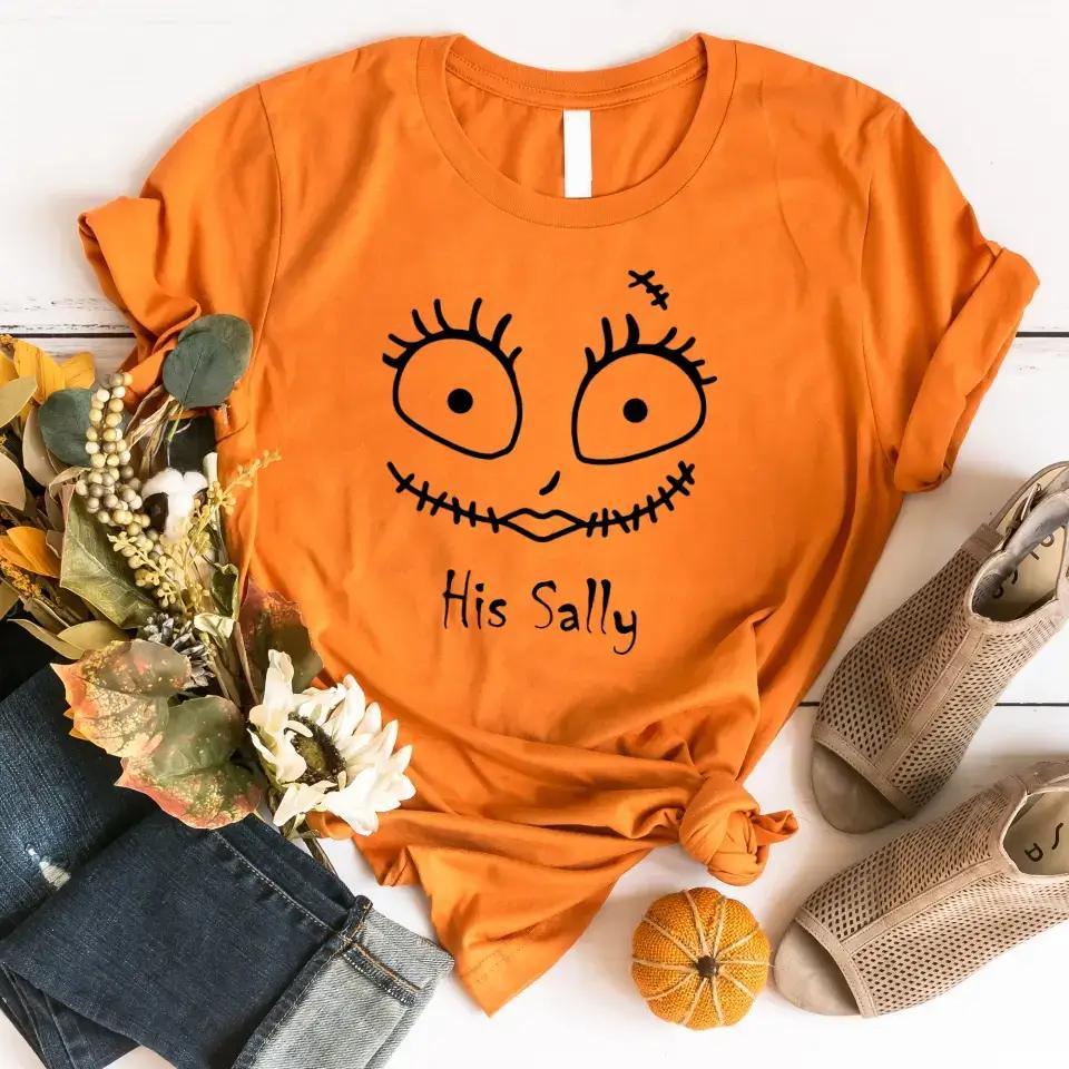 Orange crewneck Halloween tee with stitched face graphic and 'His Sally' text.