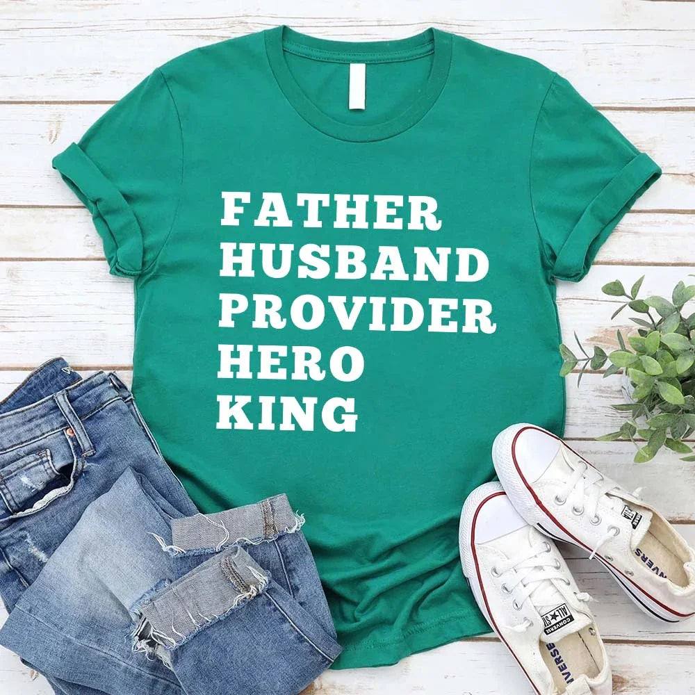 Green crewneck T-shirt with stacked "FATHER HUSBAND PROVIDER HERO KING" print