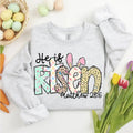 Sport grey crewneck sweatshirt with 'He is Risen' bunny graphic and 'Matthew 28:6' print