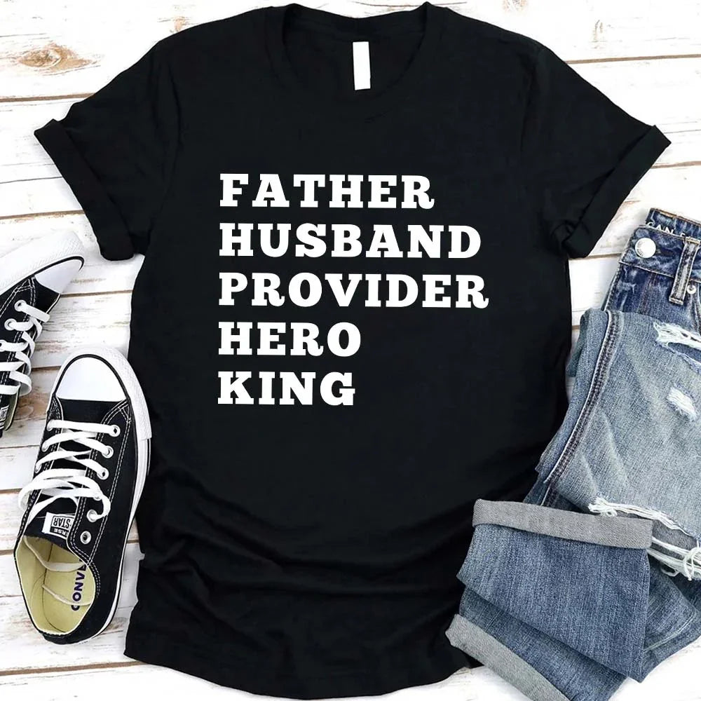 Black crewneck T-shirt with stacked "FATHER HUSBAND PROVIDER HERO KING" print