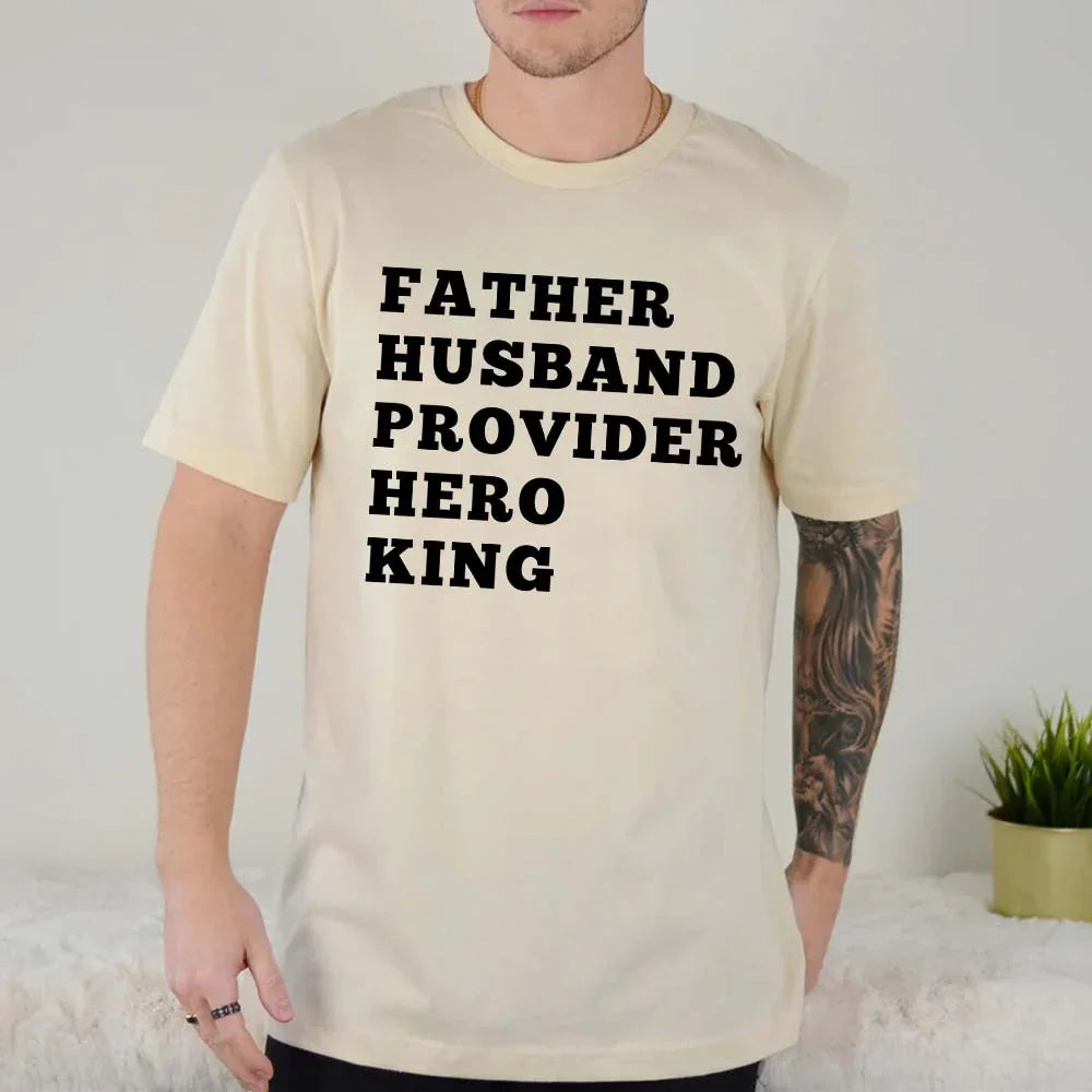 Cream graphic T-shirt with black stacked text: FATHER HUSBAND PROVIDER HERO KING