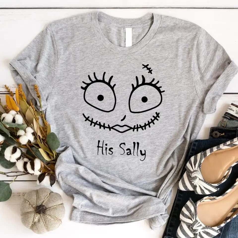 Grey crewneck Halloween tee with stitched face graphic and 'His Sally' lettering.