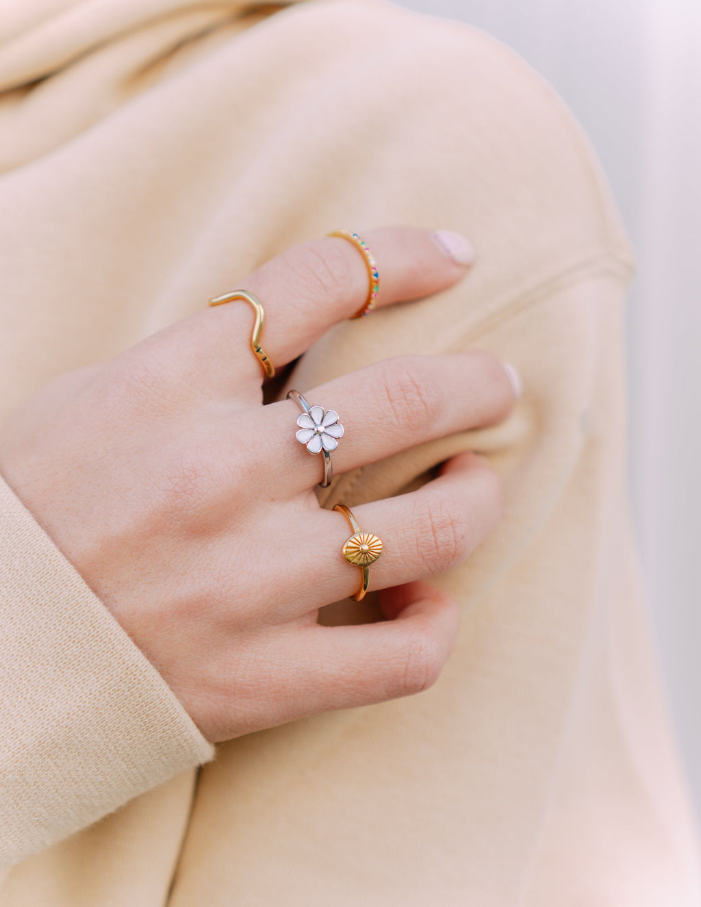 Gold-tone sunburst ring with raised center and thin band