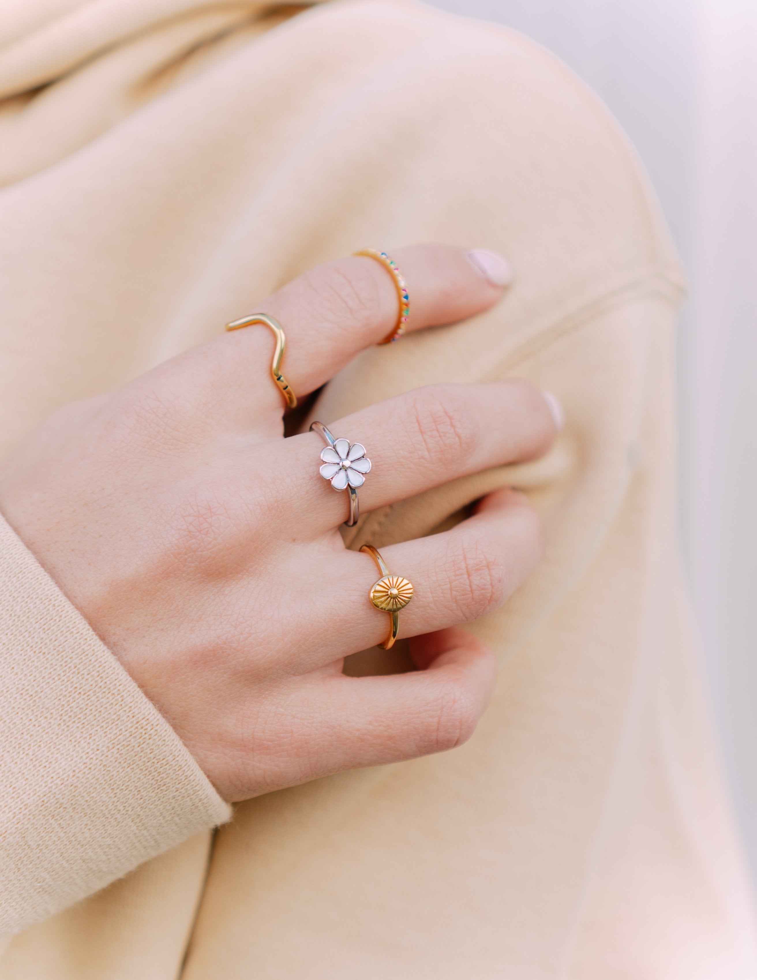 Gold-tone sunburst ring with raised center and thin band