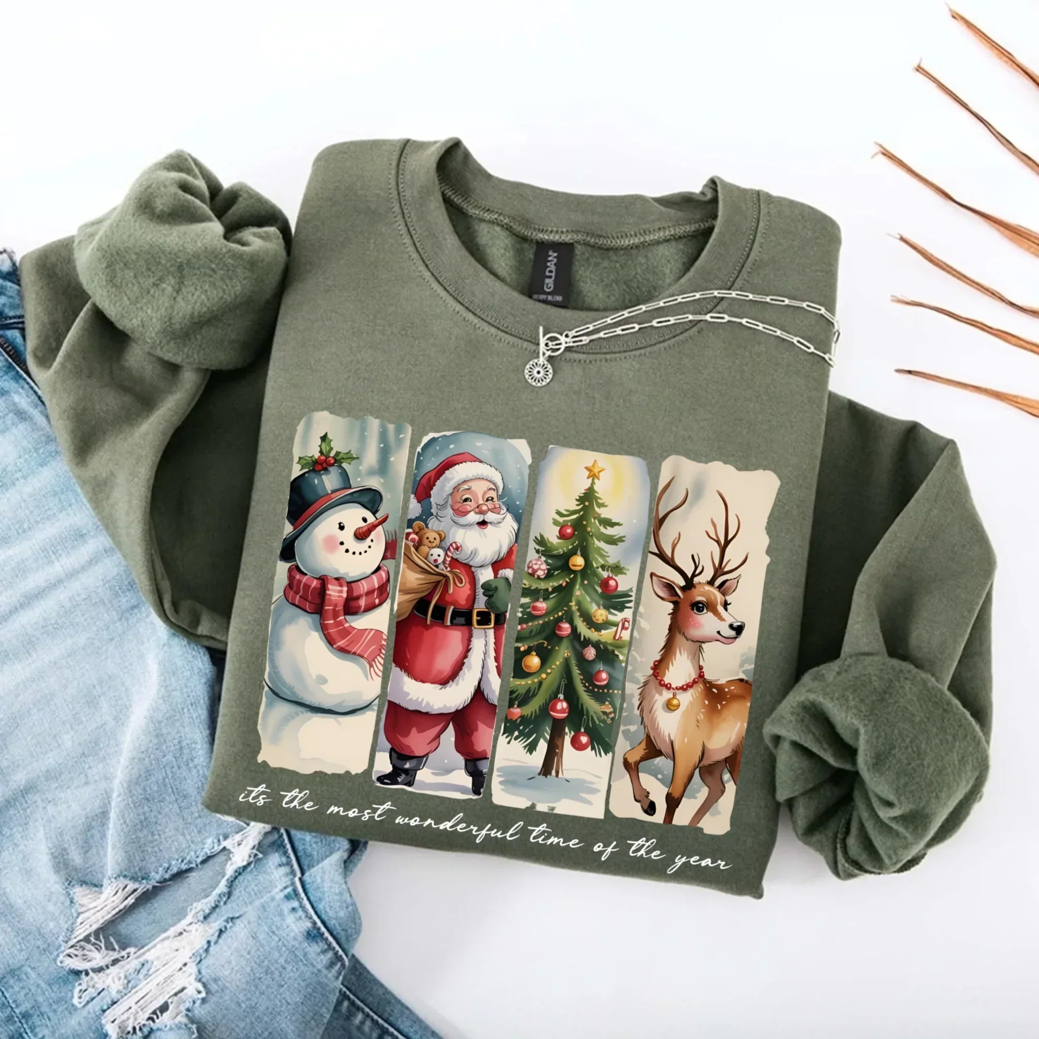 Olive green crewneck sweatshirt with Santa, snowman, tree and reindeer graphic