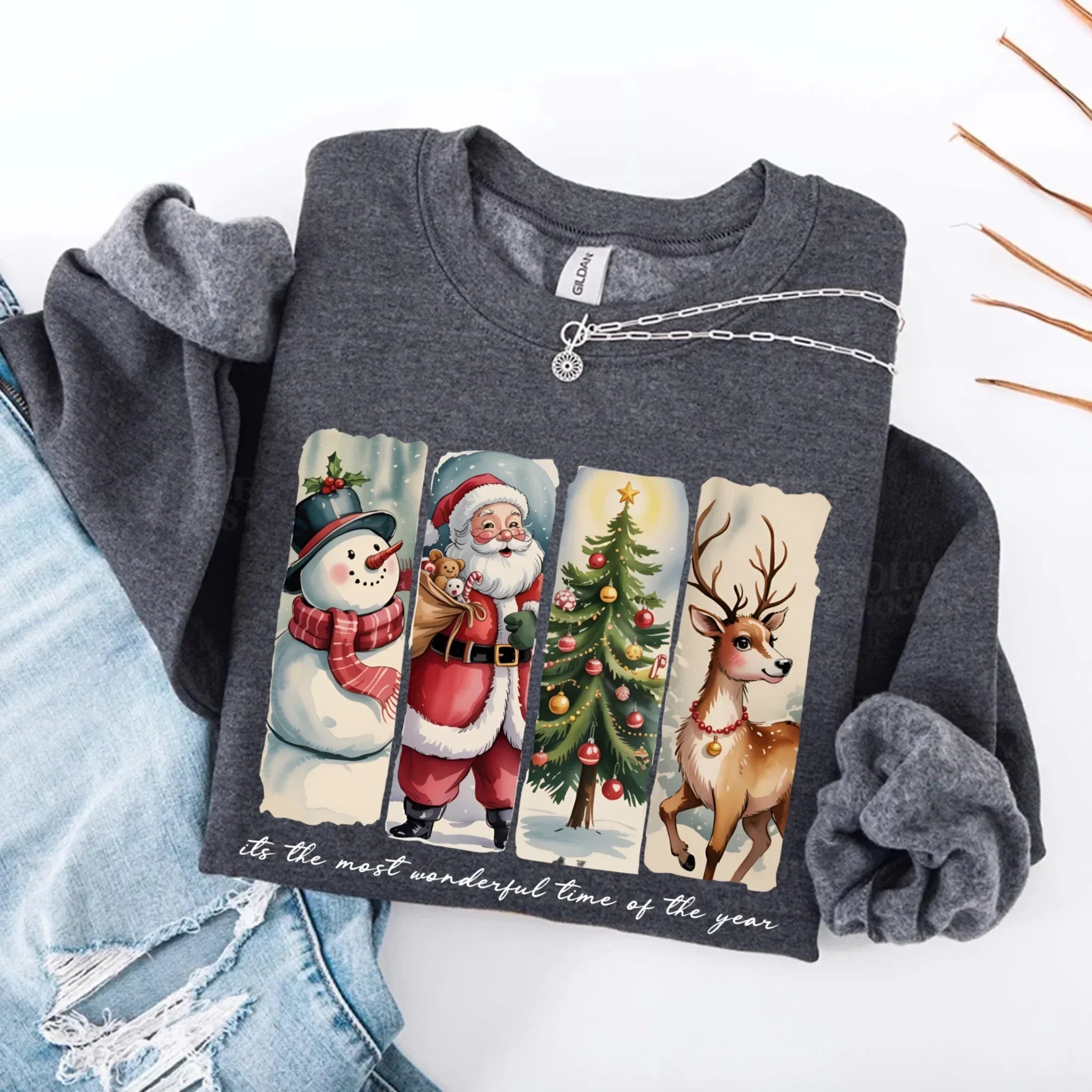 Dark heather grey crewneck sweatshirt with Santa, snowman, tree and reindeer graphic