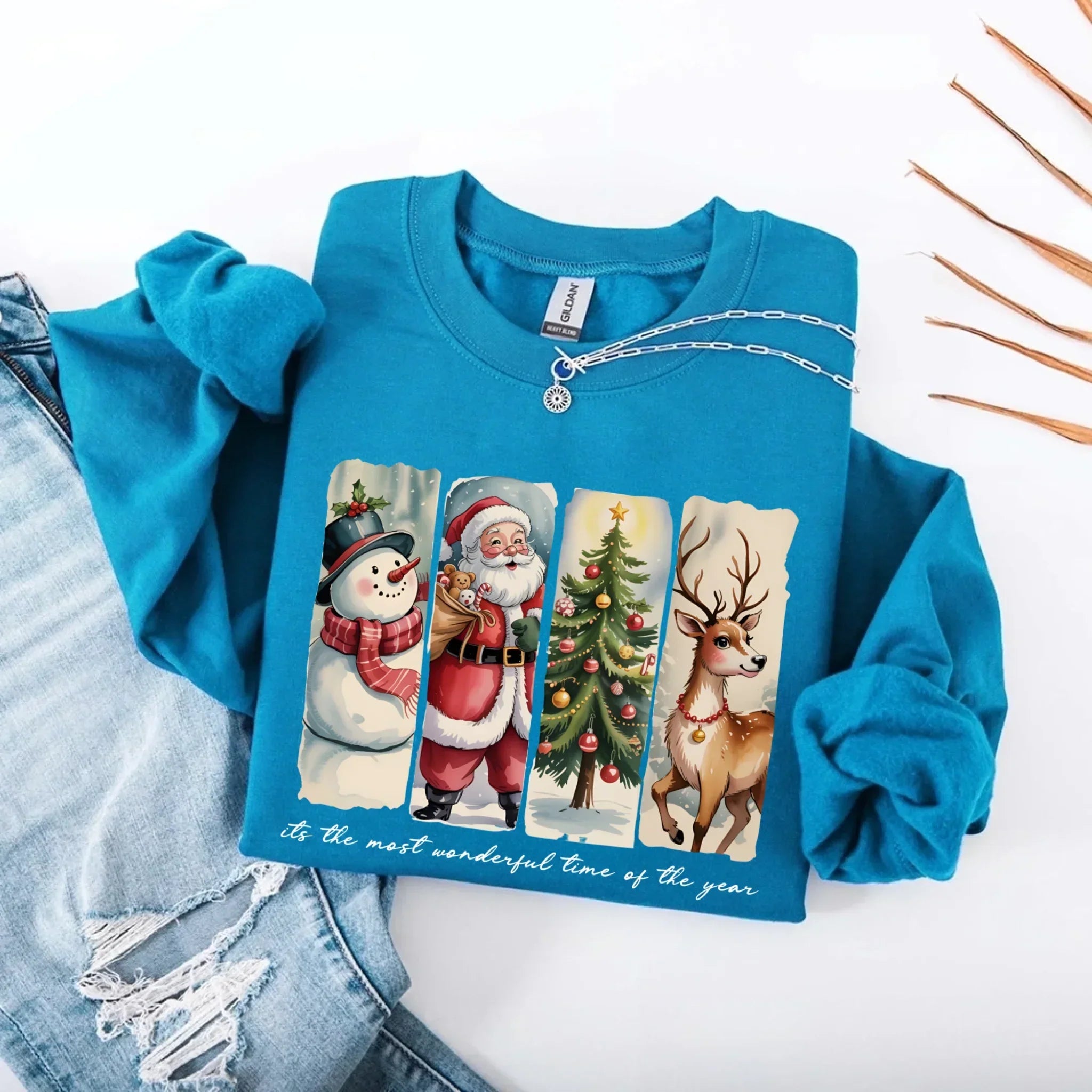 Blue crewneck sweatshirt with Santa, snowman, tree and reindeer graphic