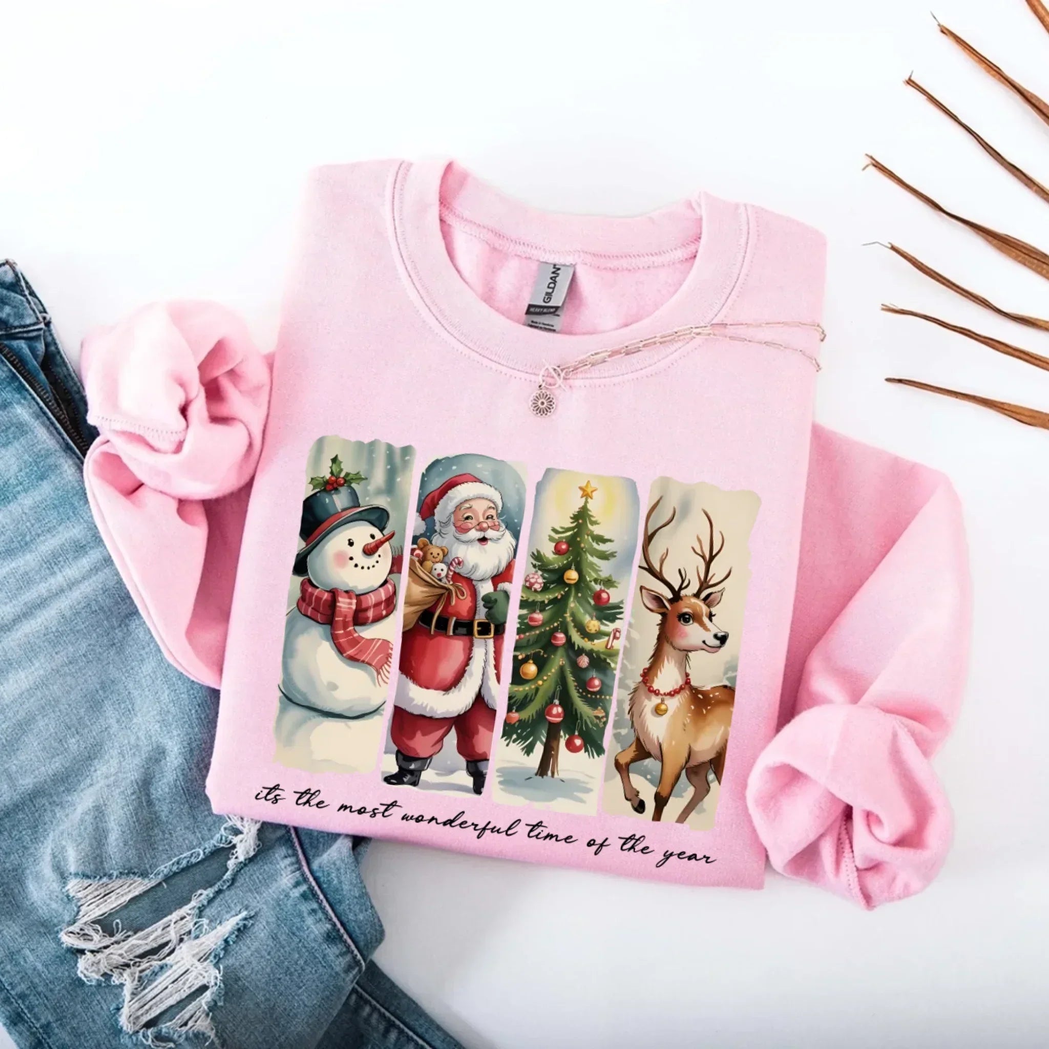 Light pink crewneck sweatshirt with Santa, snowman, tree and reindeer graphic