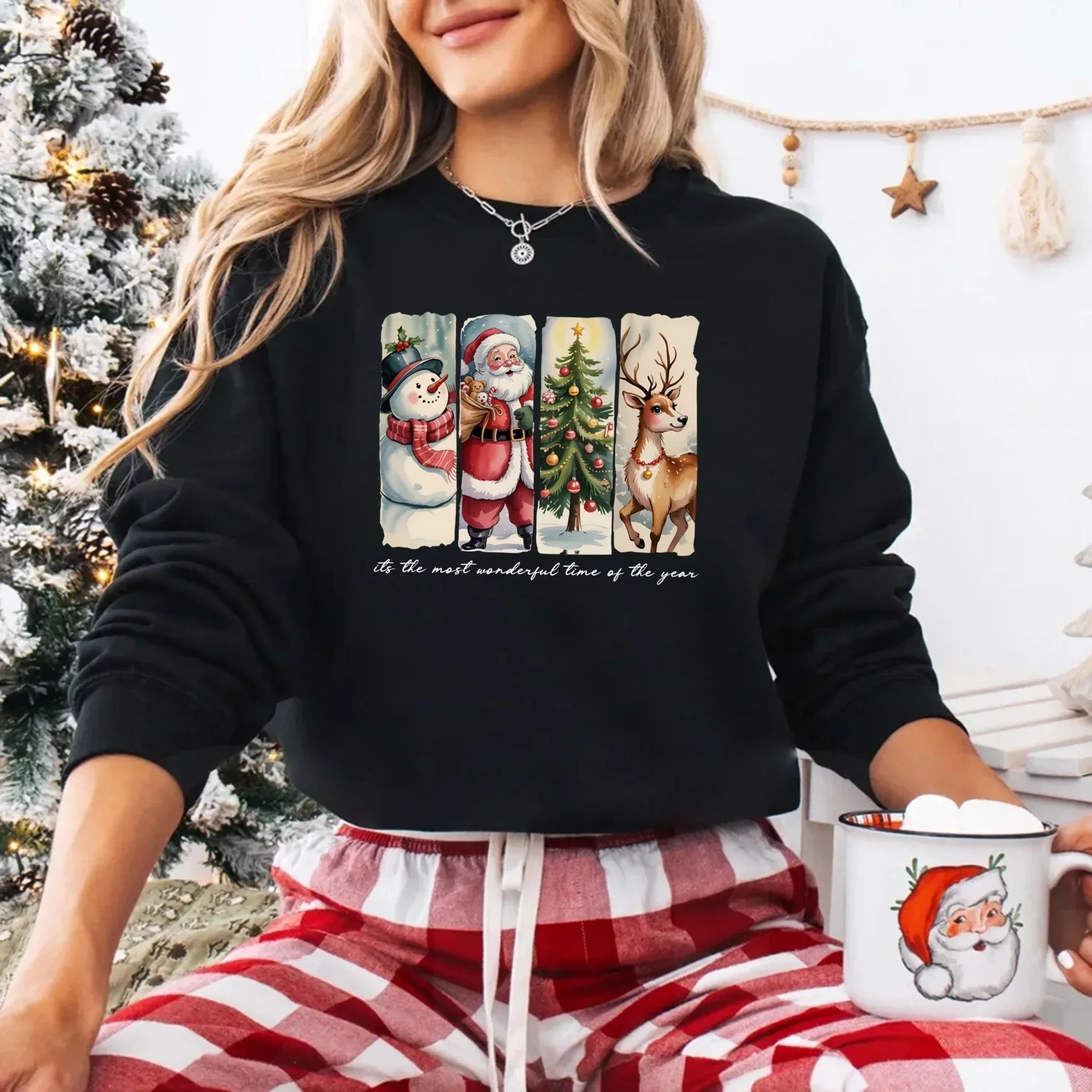Dark crewneck sweatshirt with Santa, snowman, tree, and reindeer front graphic