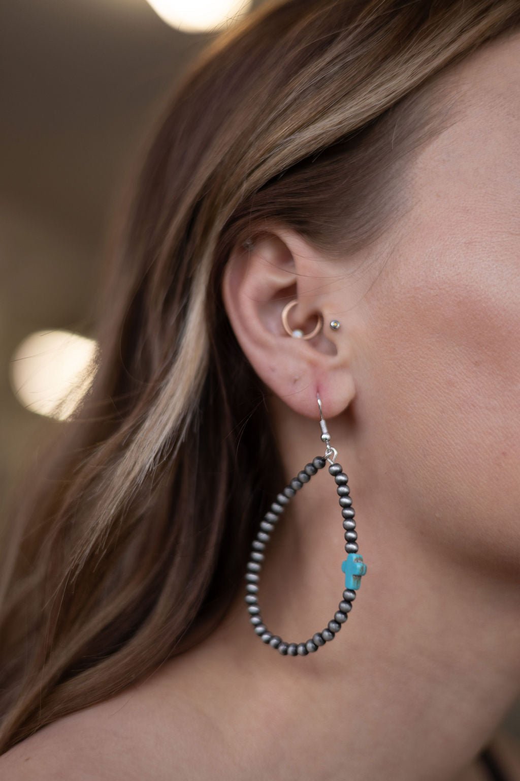 Turquoise cross drop earrings with black bead hoops for pierced ears