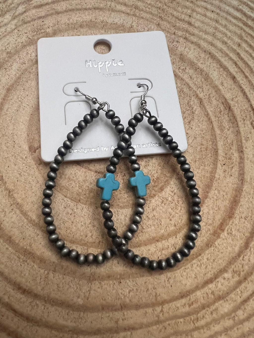 Black beaded hoop earrings with turquoise cross dangle, silver-tone hooks