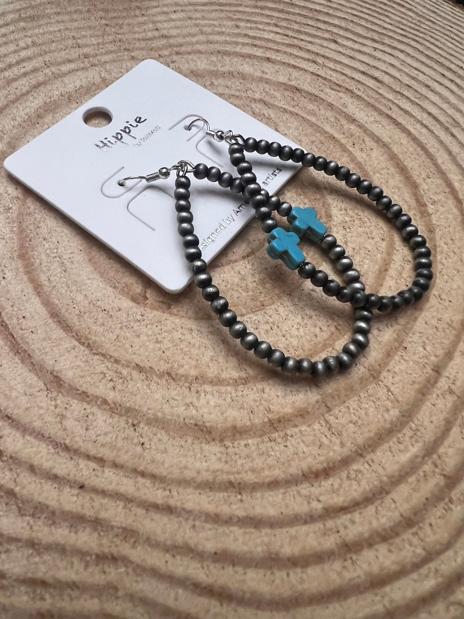 Pair of black bead hoop earrings with turquoise cross dangle