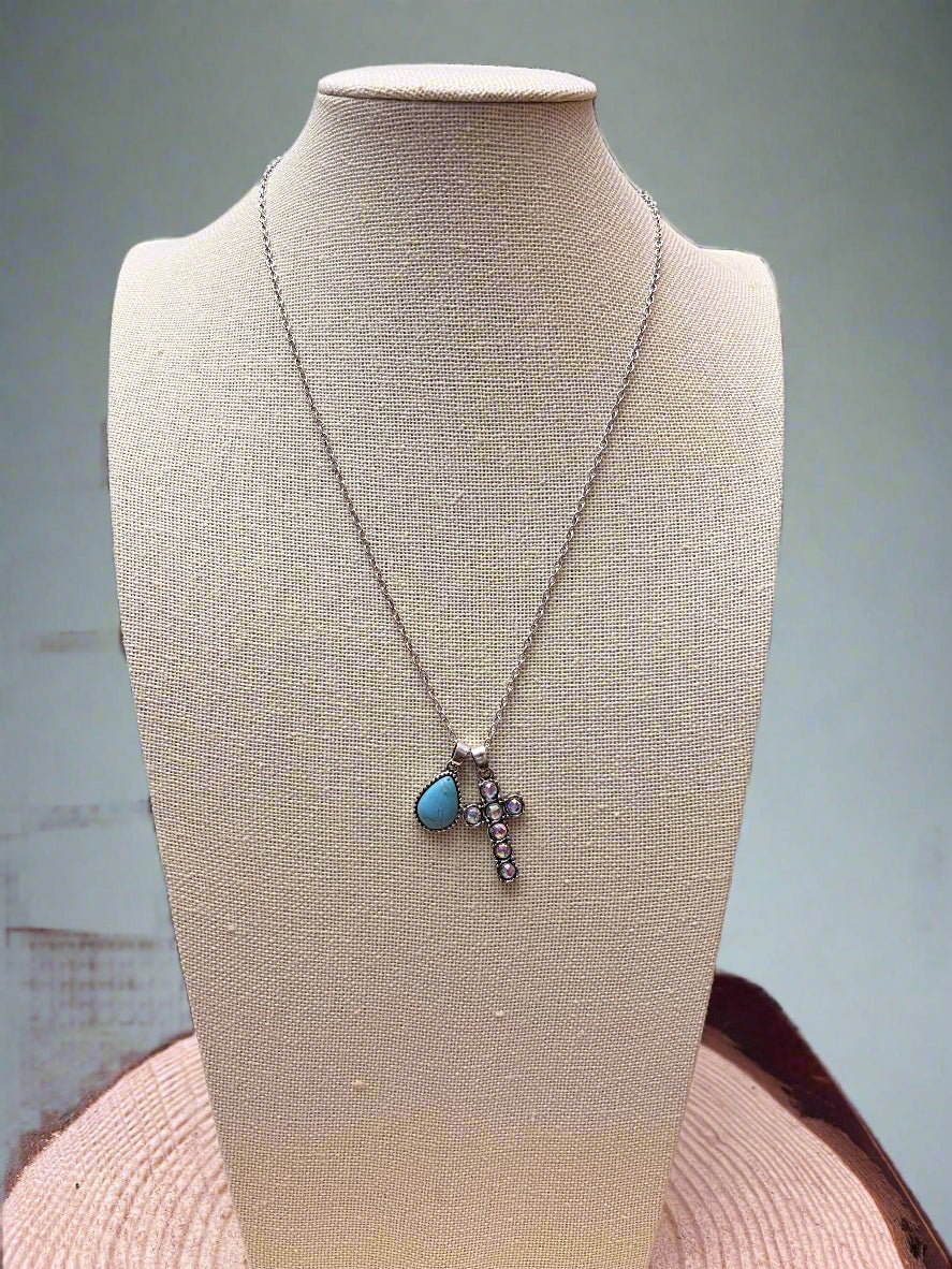 Turquoise dangle pendant western cross necklace on silver chain, mannequin