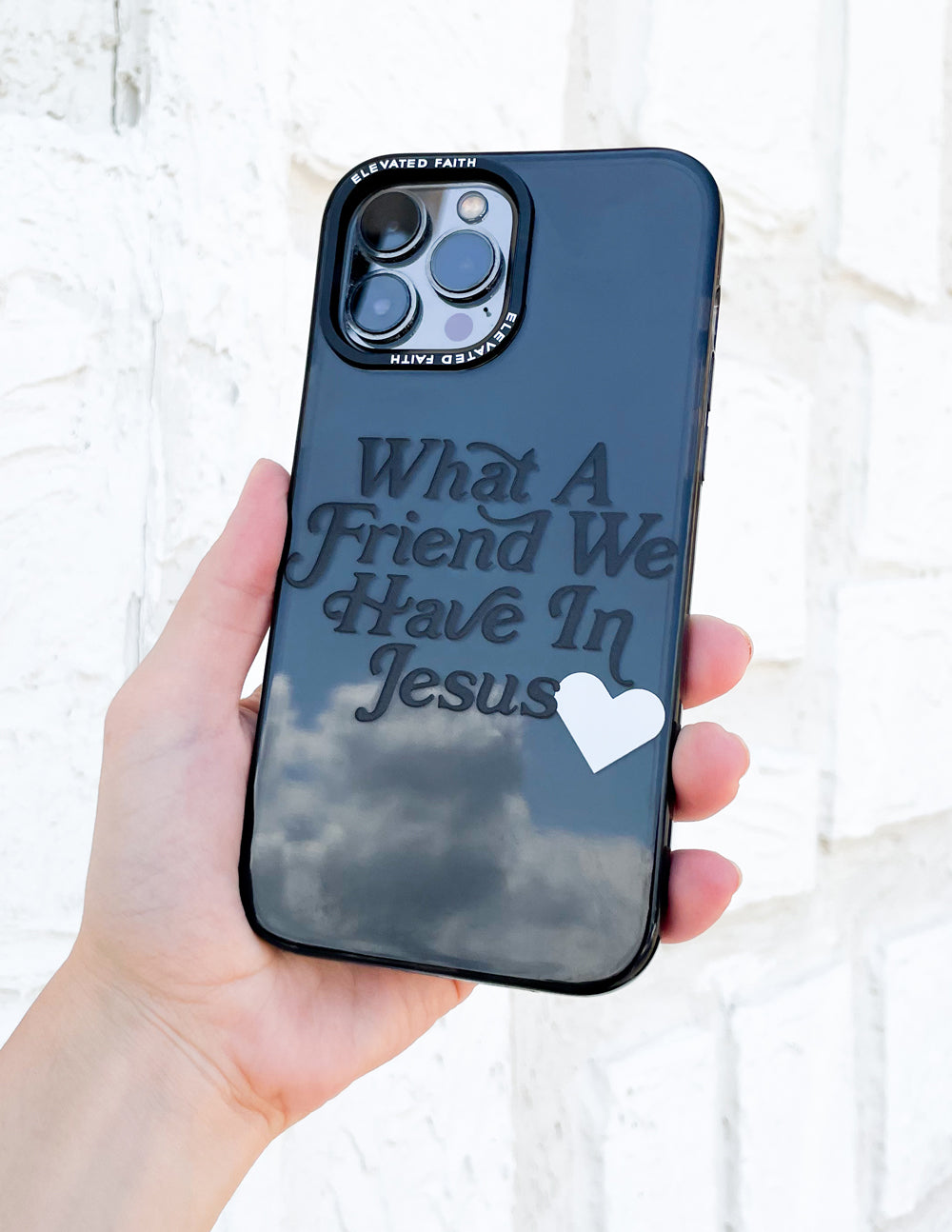 Phone case with 'What A Friend We Have In Jesus' text and white heart, blue shell