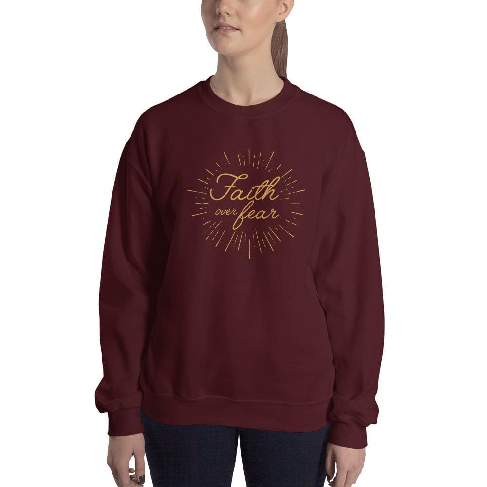 Women's crewneck sweatshirt in maroon with gold 'Faith over fear' chest graphic.