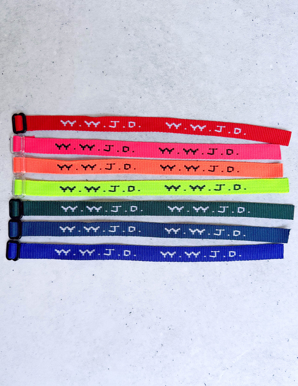 WWJD bracelet assortment, multiple colored fabric bands with repeating symbol pattern