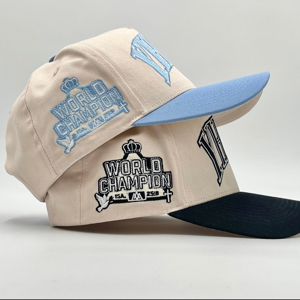 Cream snapback cap with World Champion side embroidery and blue brim