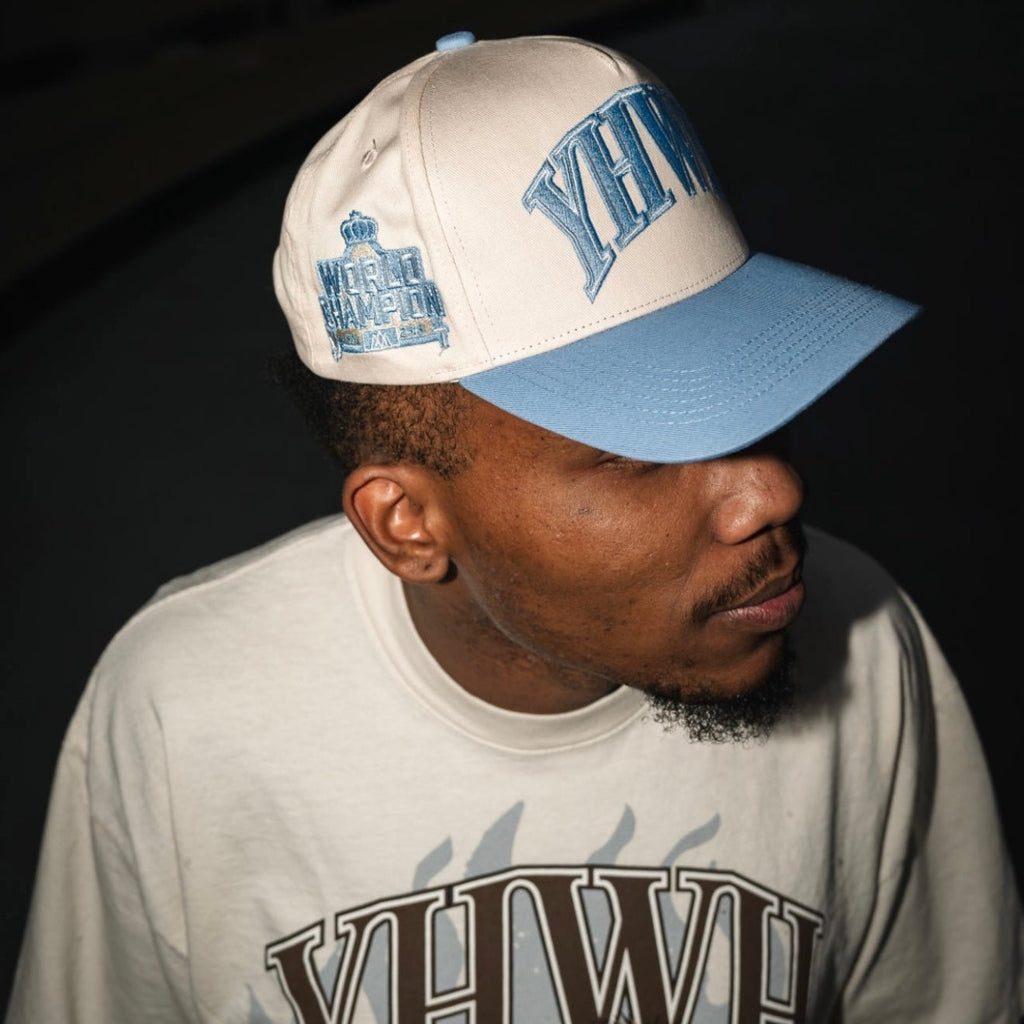 Cream and baby blue snapback cap with YHWH front and World Champion side patch