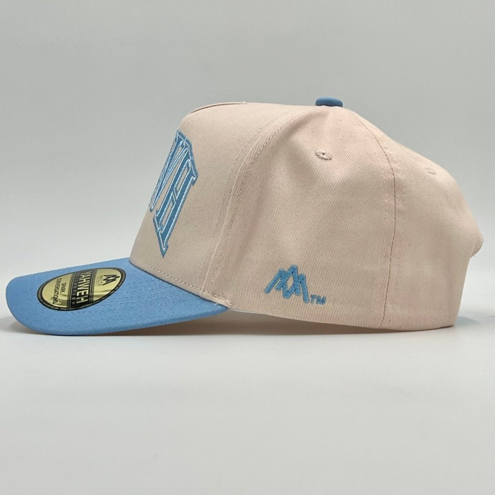 Cream and baby blue snapback cap with side YHWH mark and blue brim