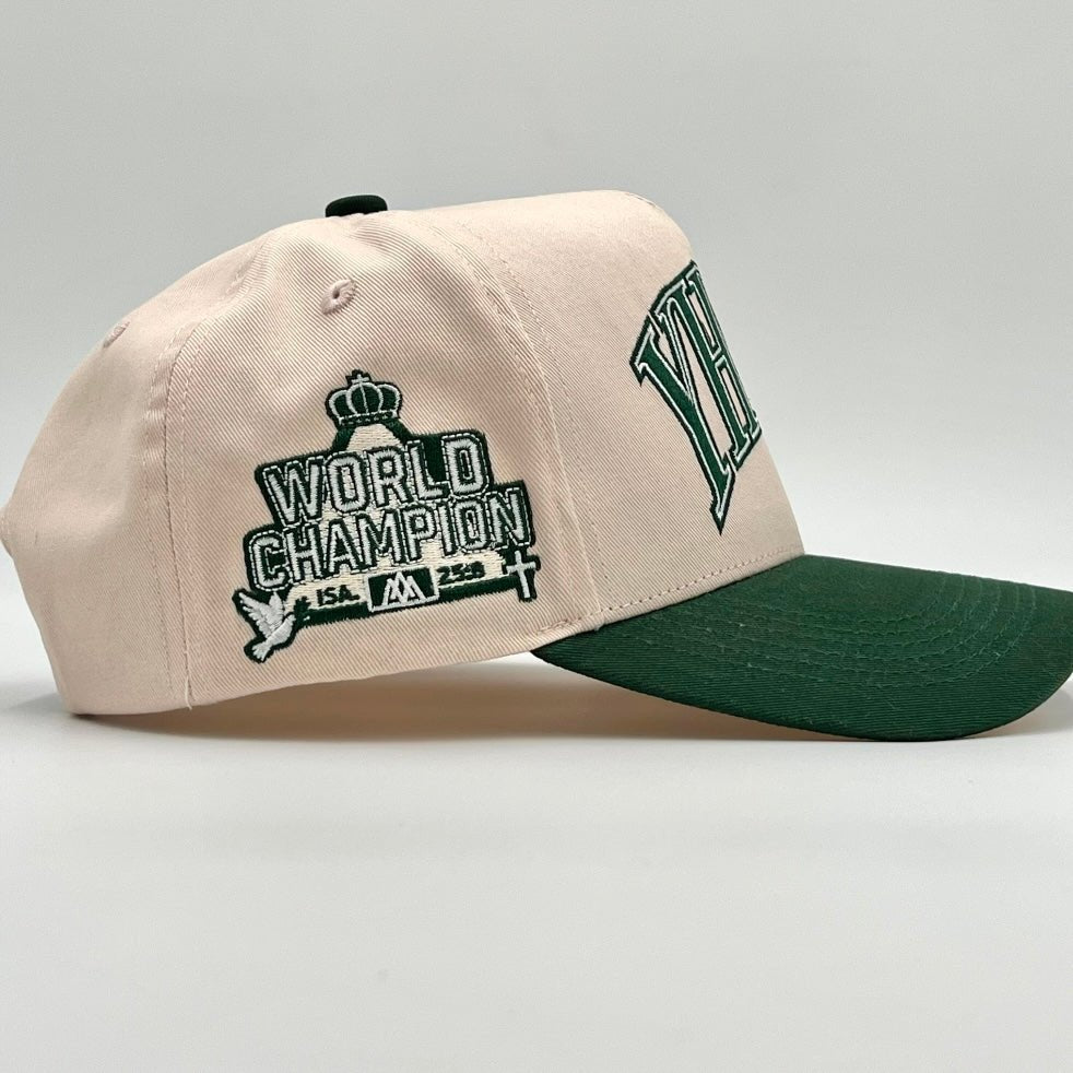 Cream cap with green brim and World Champion graphic patch